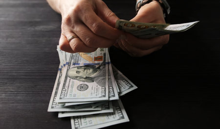 Girl Counting Hundred Dollar Notesの写真素材