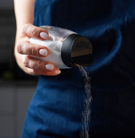 Woman Salting Food With A Salt Shaker Close Upの写真素材