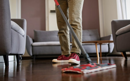 Woman Cleaner Mopping Living Room Floorの写真素材
