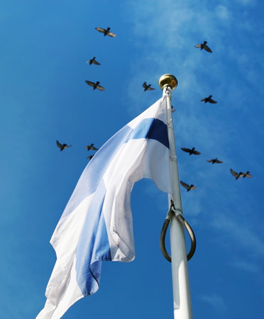 Finland Flag Waving Against The Sky Background On A Poleの写真素材