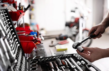 Auto Mechanic With Ratchet Wrench And Socket Tool In Garageの写真素材