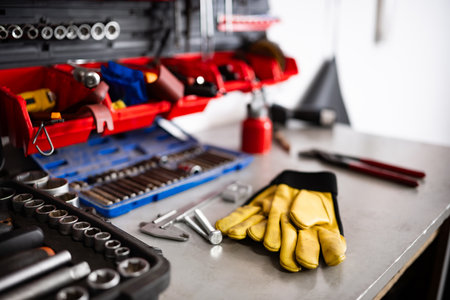 Yellow Protective Gloves On A Mechanic Workbench With Instruments And Toolsの写真素材