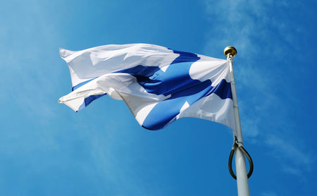 National Flag Of Finland Waving Against The Sky Background On A Poleの写真素材