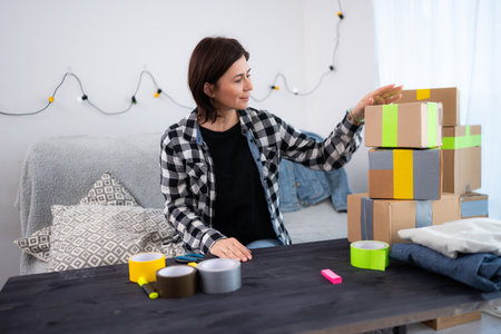 Girl Prepares Packages For Delivery, Running A Small Handmade Business At Homeの写真素材