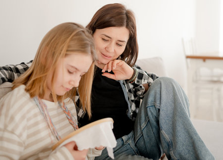 Mother Teaches Embroidery On A Hoop To Little Girl, Holding Thread With A Needle And An Embroidery Hoopの写真素材