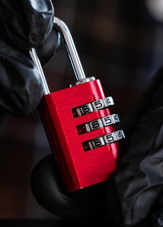 Person In Black Gloves Setting The Open Code On A Coding Lock For Luggage And Lockers