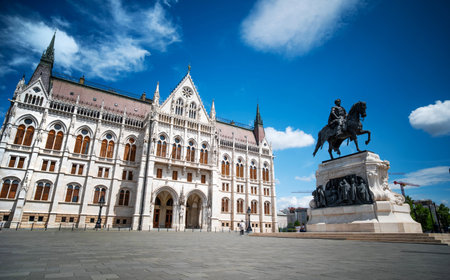 Hungarian Parliament Building In Budapest With A Statue Against Clouds In The Skyの写真素材