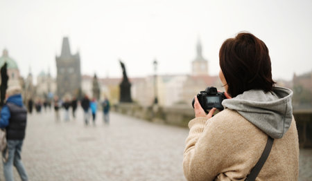Girl Captures Stunning Charles Bridge. Tourists Stroll Through Prague Magicの写真素材