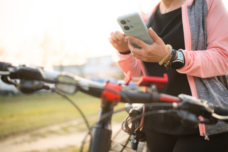 Woman Checking Bike Route On A Smartphone With Gps Mapの写真素材