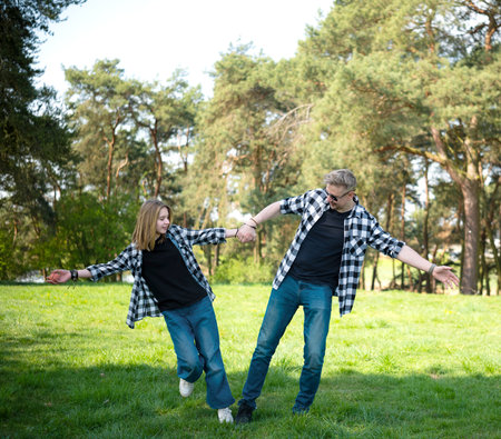 Father And Daughter Having Fun Playing Outdoors In A Summer Parkの写真素材
