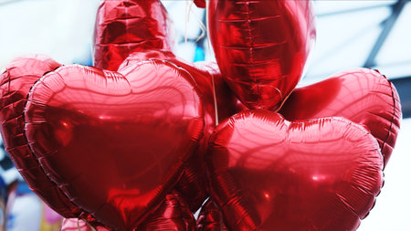 Red Heart-Shaped Balloons Tied Together On Stringsの写真素材