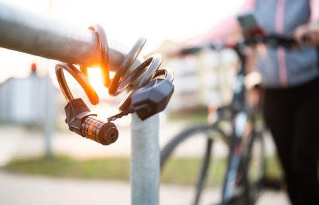 Bike Code Lock Against Bike Rider On A Bicycle Parking Rackの写真素材