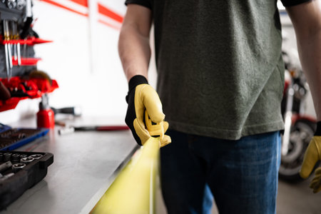 Worker Holding A Measuring Tape In Hands At The Workspaceの写真素材