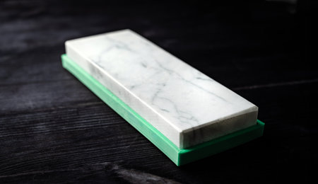 Kitchen Sharpening Stone For Knives On Dark Background