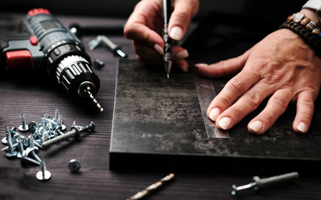 Female Carpenter Creates Handmade Wooden Furniture For Stylish, Modern Kitchensの写真素材