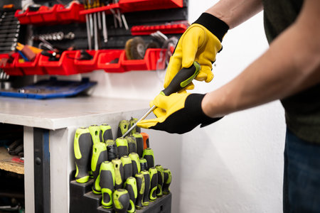 Mechanic Choosing A Screwdriver In Screwdriver Set At An Auto Service