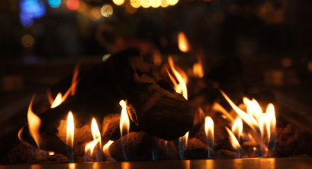 Burning Wood Logs Fire In A Cozy Outdoor Patio Gas Heater With A Glowing Lights Background