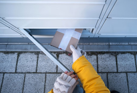 Girl Picks Up A Delivered Cardboard Box From A Parcel Automated Locker In Winter
