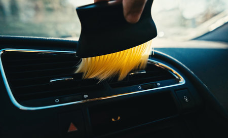 Driver Cleaning Dust Off The Car Interior With A Brush, Close Upの写真素材