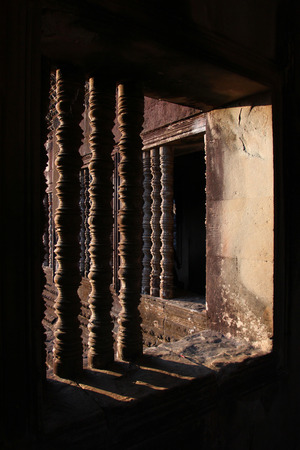 Window of the ancient temple in the complex of Angkor, near the ancient city of Siem Reap.の写真素材