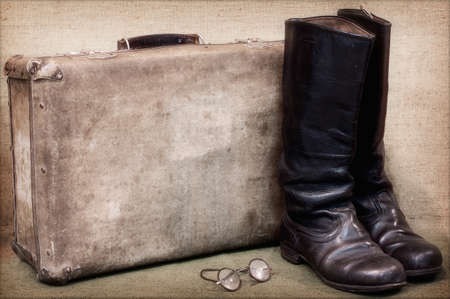 from distant wanderings to return in boots and with a suitcaseの写真素材