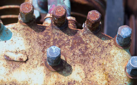 Old flange on the mechanism with the rusted bolts and old paint.