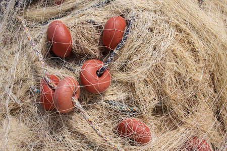Fishing net with red bobber, fishermans equipmentの写真素材