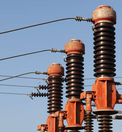 Red and brown high voltage isolation with ceramic body on blue sky