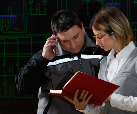 Man and woman are making consultation in power distribution control center