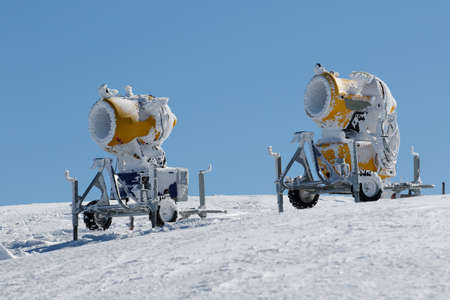 Two yellow snow cannons on the Kopaonik mountain