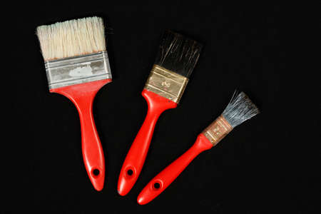 Top view of three red used paintbrushの写真素材
