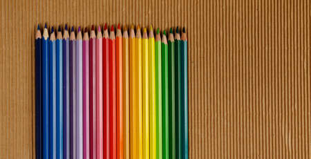 Multicolored crayons on wrinkly brown paperの写真素材