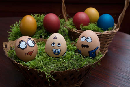 Heppy egg face family in wicker basketの写真素材