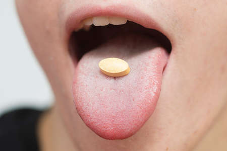 Young boy swallow the vitamin c pill