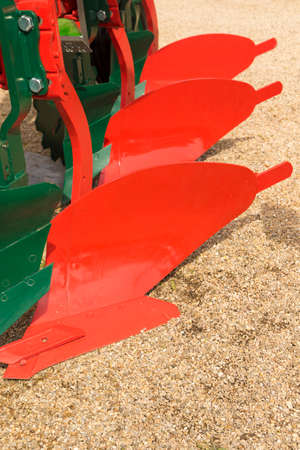 Detail of red plough for a Farming Tractor