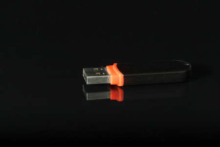 Black UBS flash drive  on black wit reflection