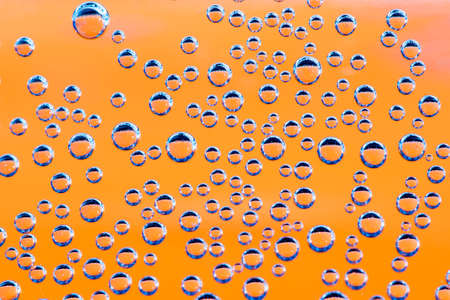 Group of orange and blue air  bubbles in waterの写真素材