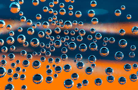 Group of orange and blue air  bubbles in waterの写真素材