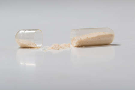 Broken transparent  antibiotic capsule on the white