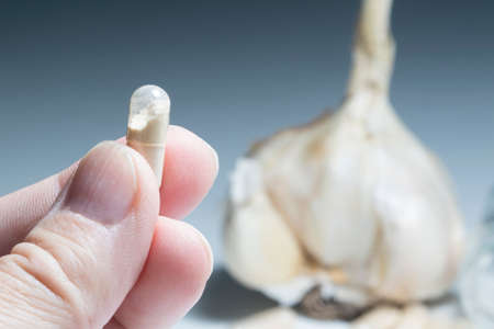 Man takes garlic capsule, flu virus protection