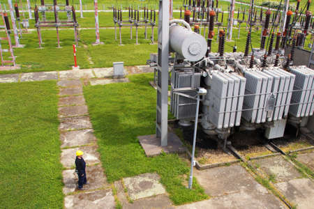 Worker in  high voltage switchyard in electrical substation