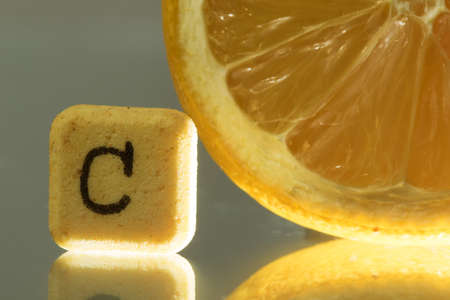 Closeup of vitamin c pill and lemon on whiteの写真素材