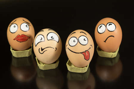 Four fanny egg faces on black background