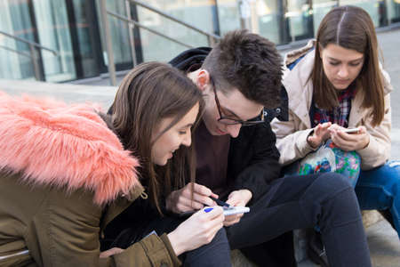 Three happy smiling  students are learning in the campus