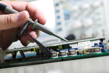 Testing electronic devices with oscilloscope in laboratoryの写真素材