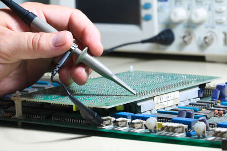  Engineer is testing electronic devices with oscilloscope in laboratory