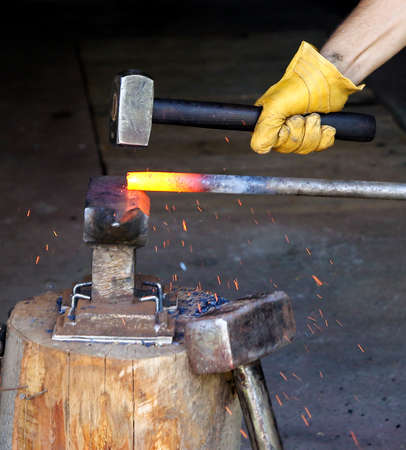 Forging hot steel with hammer, old styleの写真素材