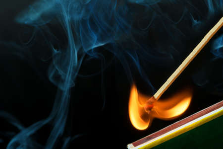 Striking a match and make a fire and smokeの写真素材
