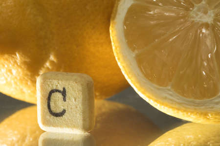 Closeup of vitamin c pill and fresh lemon