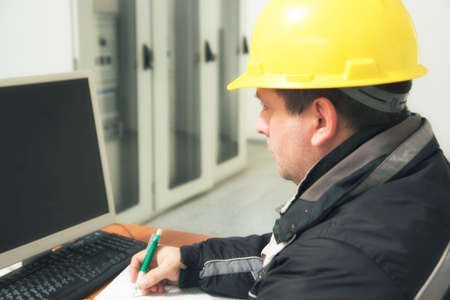 Engineer take notes  in the power plant control centerの写真素材